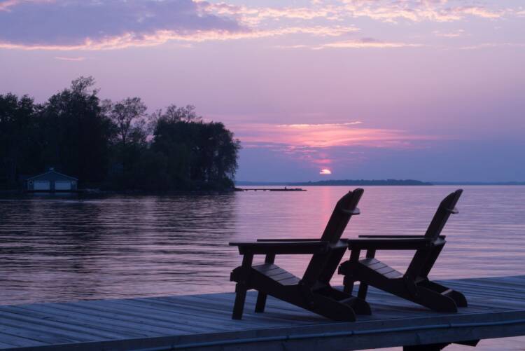 Chairs on a lake during sunset